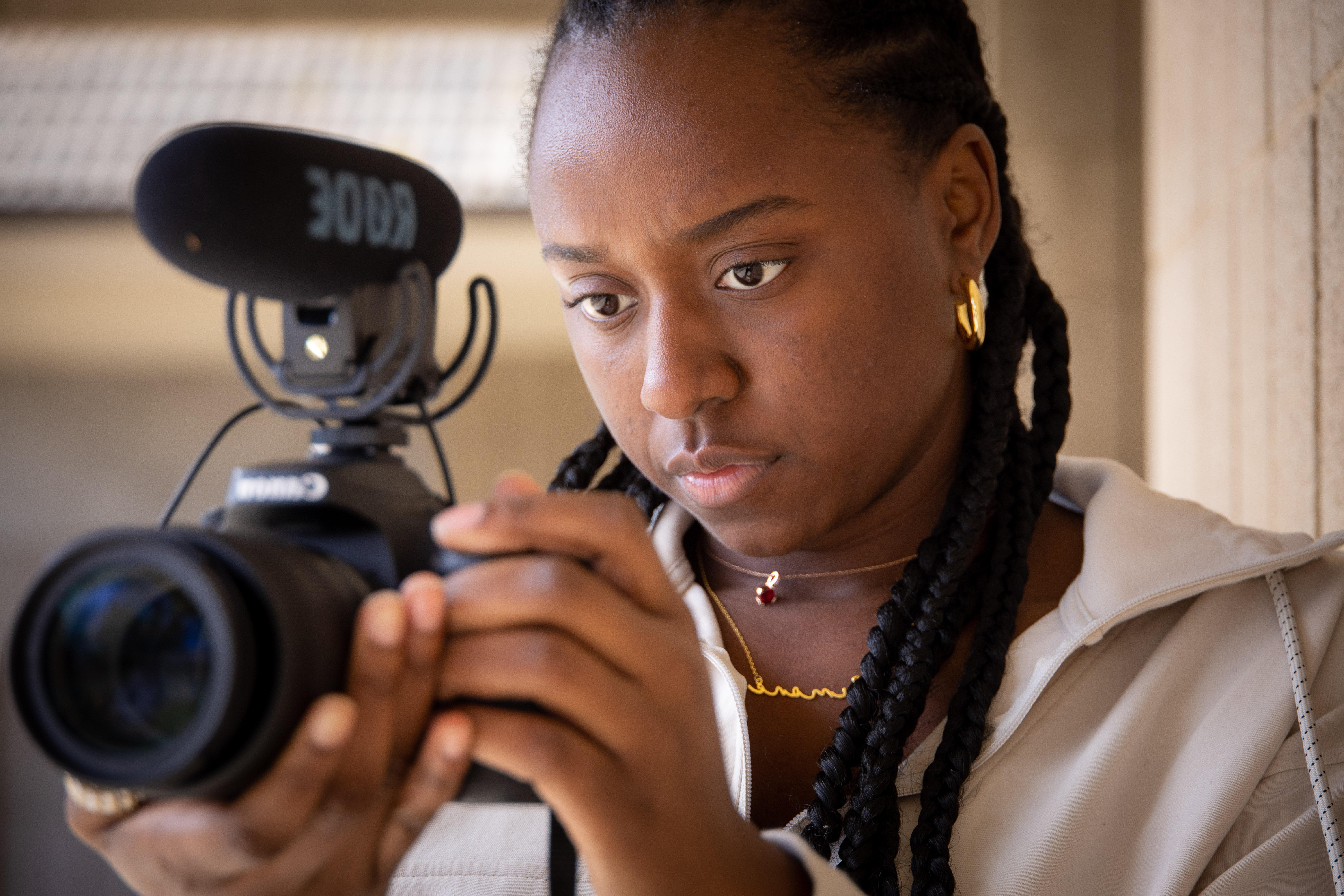 woman holding video camera